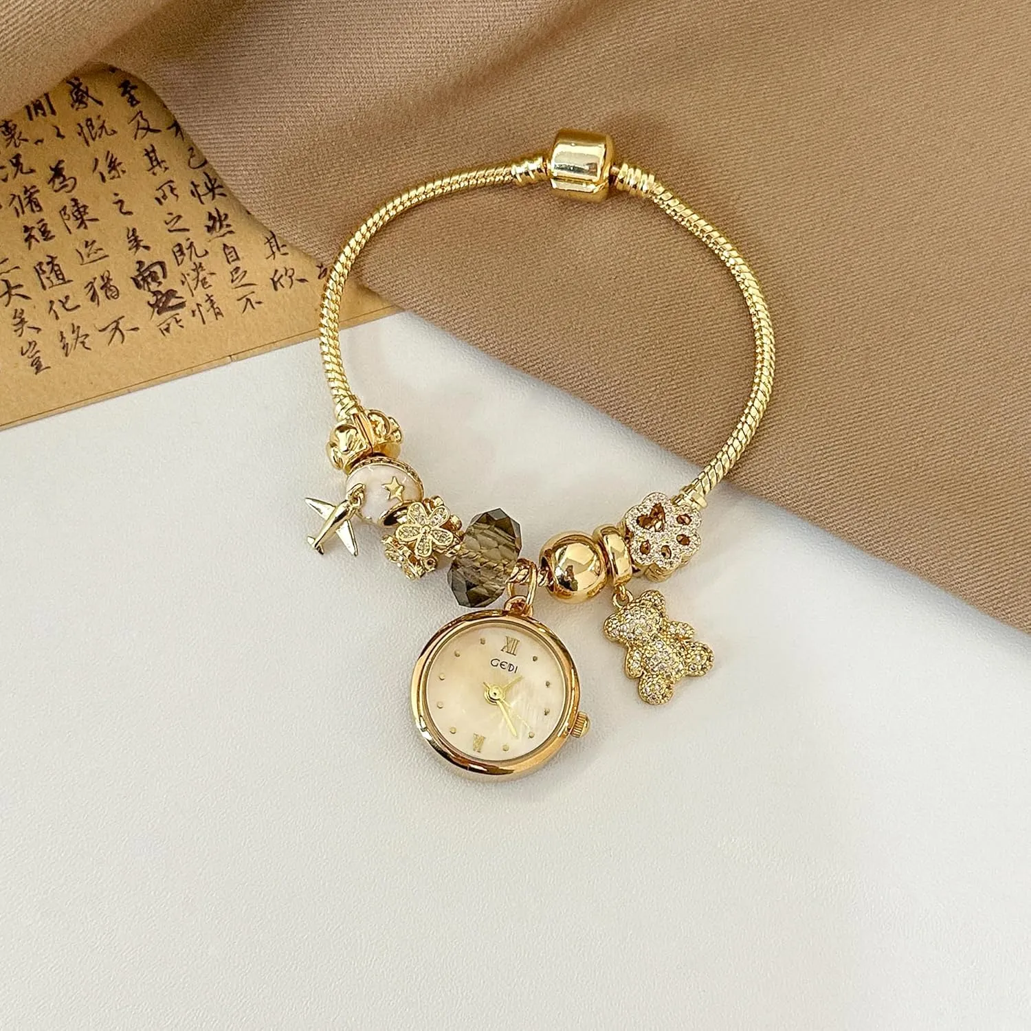 Women's Stylish Premium Crystal Gold-Tone Charm Bracelet Quartz Watch Exquisite chronological DNA Jewelry Bangle Chain Wristwatch for Women CARLIEN 